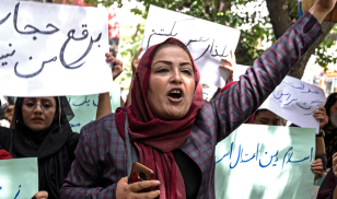 Members of Afghanistan's Powerful Women Movement, take part in a protest in Kabul on May 10, 2022. - About a dozen women chanting "burqa is not my hijab" protested in the Afghan capital on May 10 against the Taliban's order for women to cover fully in public, including their faces. 